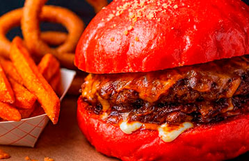 Stacked gourmet cheeseburger with fries from Food Factory Different Burgers