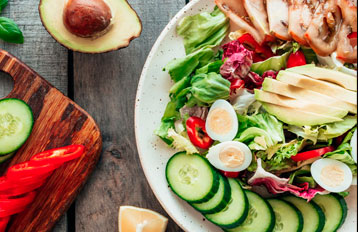 Fresh grain bowl with grilled chicken, avocado and tomatoes from The Cure Food